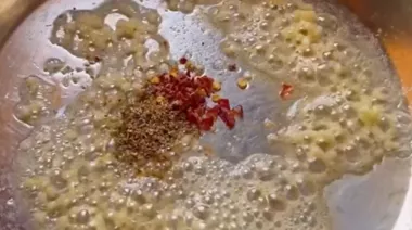 Creamy butter garlic cheesy noodles topped with cheese and spring onions